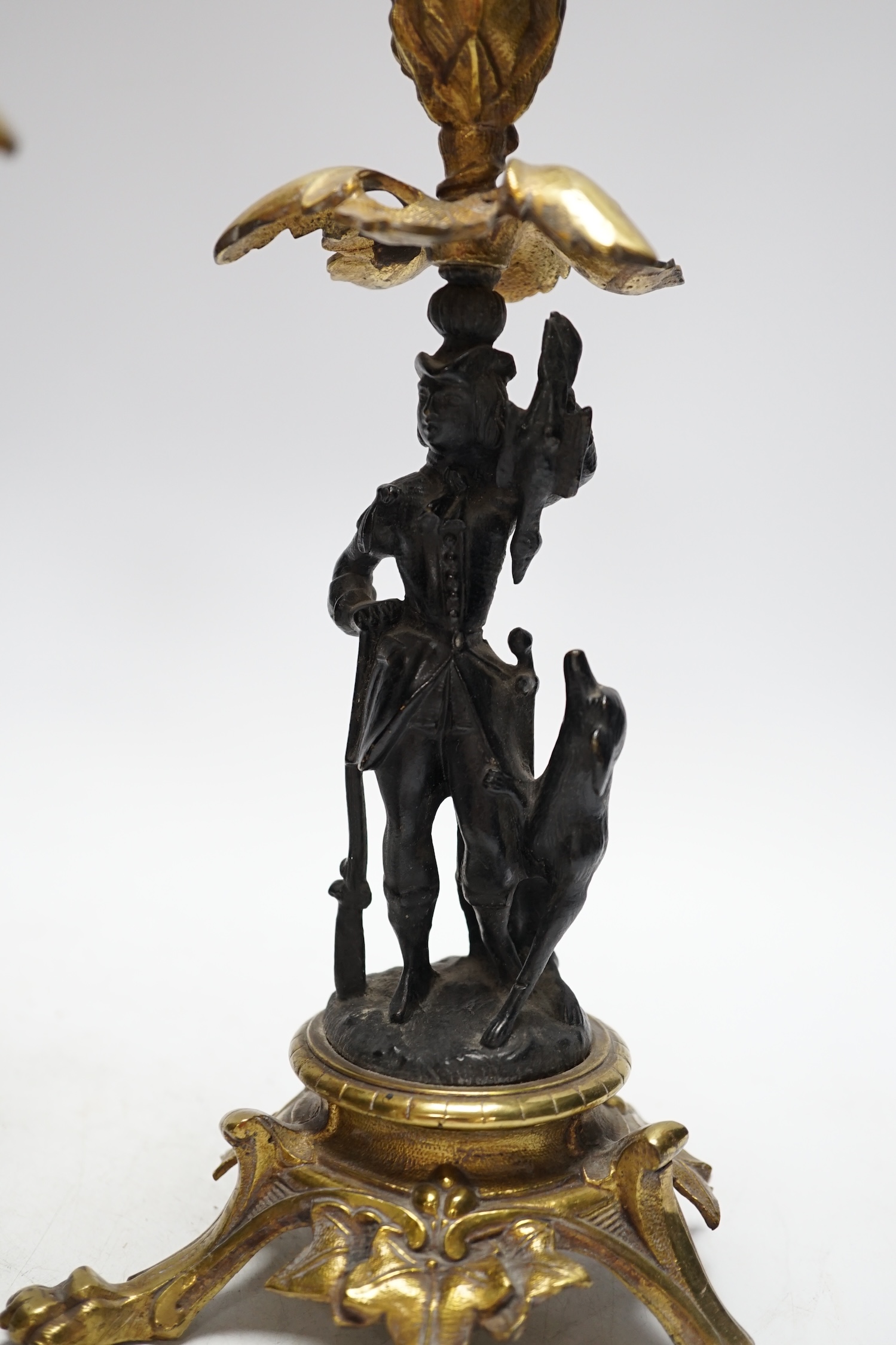A pair of Victorian bronze and gilt metal figural candlesticks and a pair of tortoiseshell and gilt metal candelabra, largest 24cm high